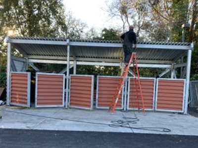 Installing roof and siding on the trash enclosure